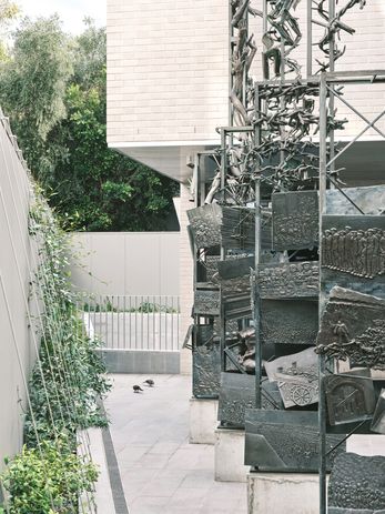 Andrew Rogers reworked his 1999 sculpture Pillars of Witness , which had been fixed to the museum facade, for reinstallation in the memorial courtyard.