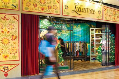 The 1920s-style steel-framed shop window is embellished red a velvet curtain.