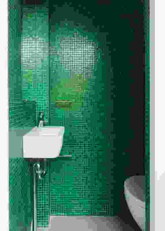 Bright green glass mosaic tiles line the second bathroom.