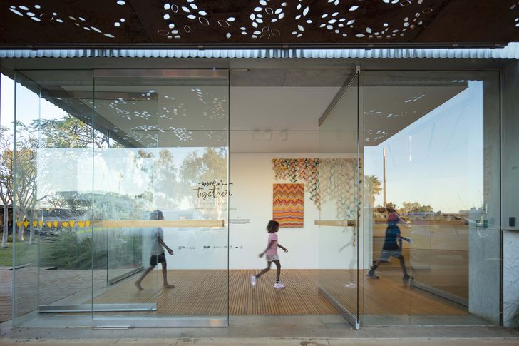 A new airlock entrance, pressurised and with a timber grilled floor, connects gallery spaces to the central courtyard, manages dust and conceals building services. Artwork (L–R): Sandra Francis, Jacky Cheng, Paula do Prado, Mulyana