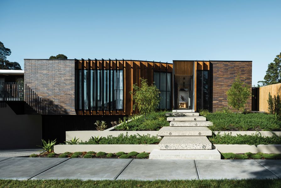 The street elevation of the Courtyard House takes subtle cues from neighbouring properties, particularly in the use of the elongated brown brick.