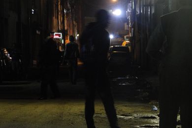 Young men at a dark street in Nairobi by SuaveKevinKariuki, licensed under CC BY-SA 4.0