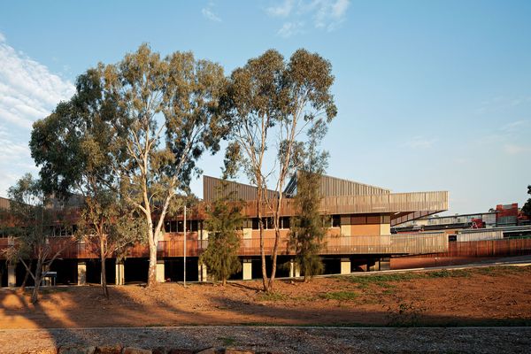 The mess hall features a sawtooth roof and is shaded on three sides by an oversized timber-clad verandah.