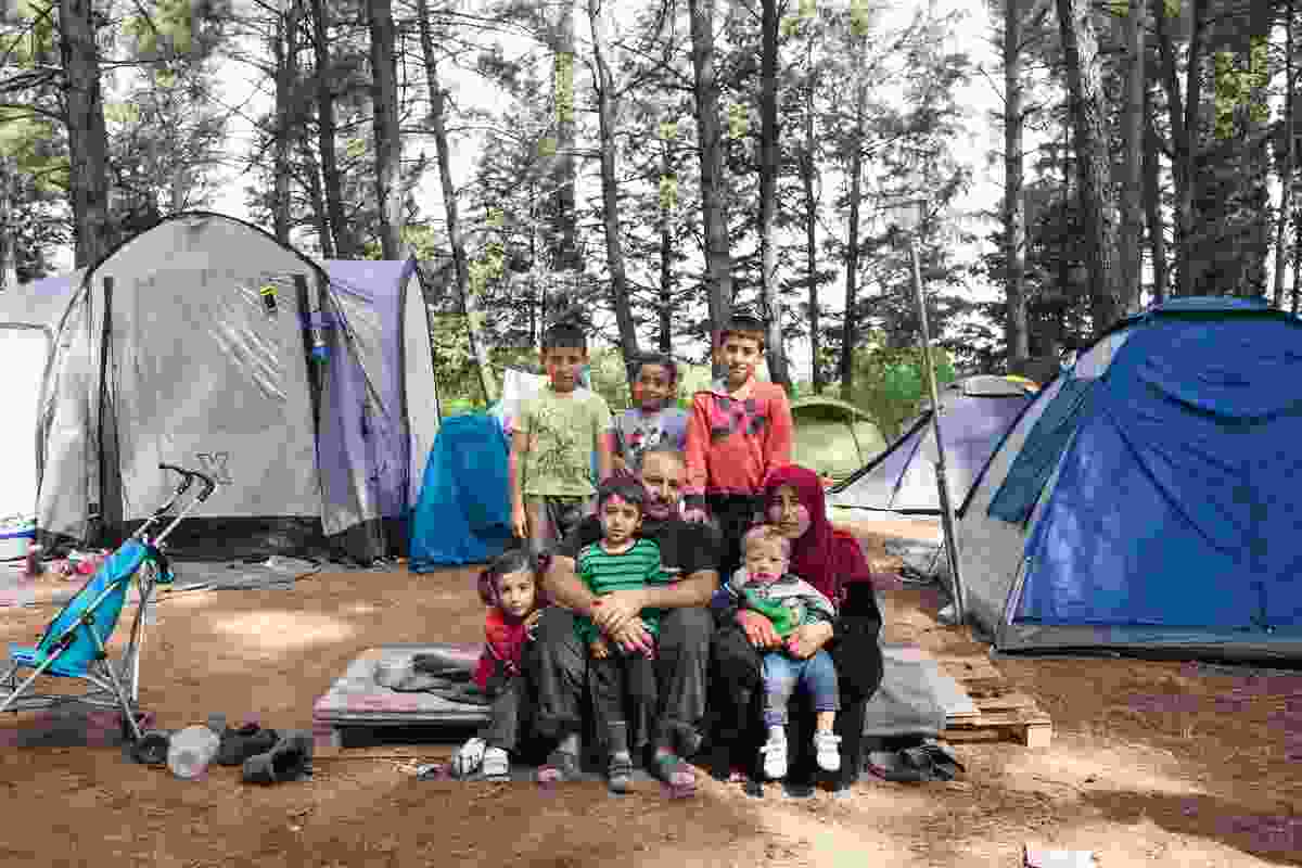 Abdisalam and his wife Rauha with their six children in a forest camp near the BP service station refugee camp of Evzoni, Greece. They left their home in Deir ez-Zor, Syria, in September 2012, and after spending years in Lebanon and Turkey they arrived in Greece two months before this photo was taken.