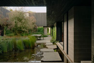 Courtyards like this lush central garden function as reference and refuge on a large, exposed site.