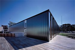 A series of vertical glass planks create a smooth east facade.