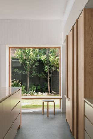 A bench seat is paired with a generously sized window to frame a north-facing garden outlook.