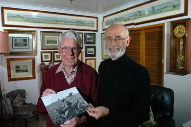 John Gray (left) holding a photograph of Thomas Charles Weston, the subject of his doctoral thesis.