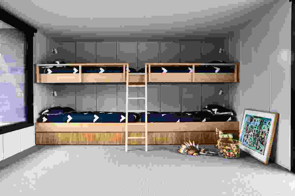 In the kids’ bedroom, top-to-toe bunk beds with integrated storage are pushed to the end wall, so the rest of the space can be used as a playroom. Artwork: Warren O’Brien.
