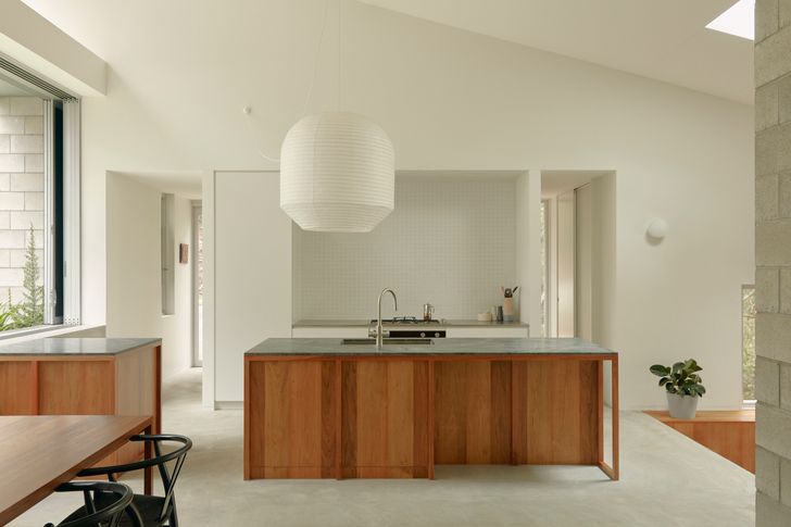 The kitchen sits below a semi-enclosed outdoor courtyard around which life revolves.