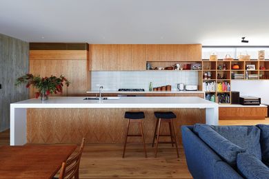 Crisp lines and oak joinery soften the exposed concrete of the northern wall.