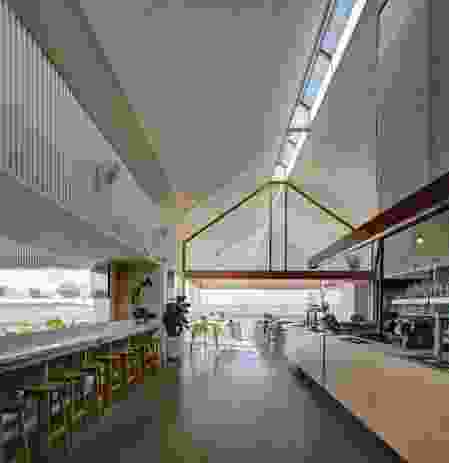 The main bar’s patterned walls and gabled vault are animated by changing sun shafts that enter through the linear skylight.