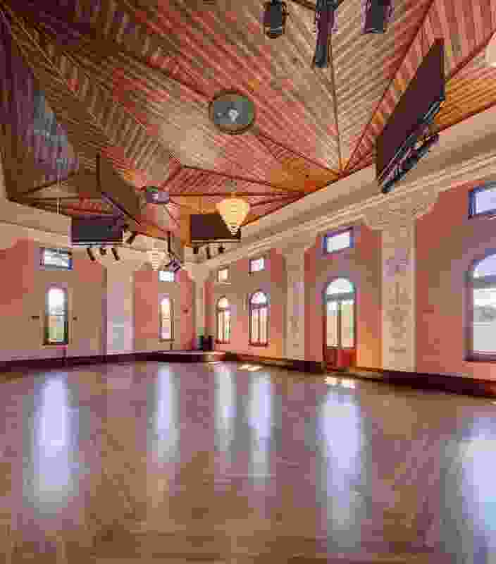 The restored main hall regains its original pink plasterwork and elaborate ceilings of  red cedar and pine. 