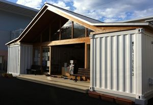 Ban’s community center is a large pitch-roofed space with amenities tucked into shipping containers.