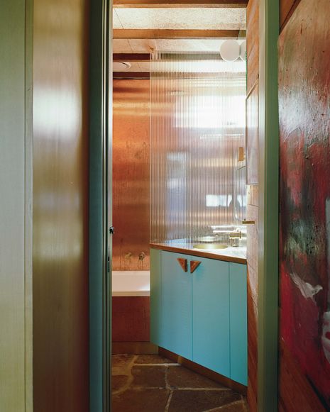 Triangular door handles, pulls and vanities playfully reference the geometries of the existing house.