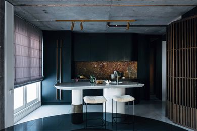 The marble of the kitchen’s bespoke island and splashback punctuate an otherwise moody colour palette.