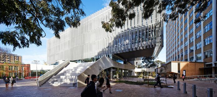 At the eastern edge, a large external stair leads students up to the atrium level and also serves as an outdoor amphitheatre.