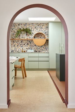 The kitchen features terrazzo, eucalyptus green and terracotta in dusty, rich tones.