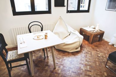 Sleeping out of the box: living room of the flat, with assorted design furniture and objects.