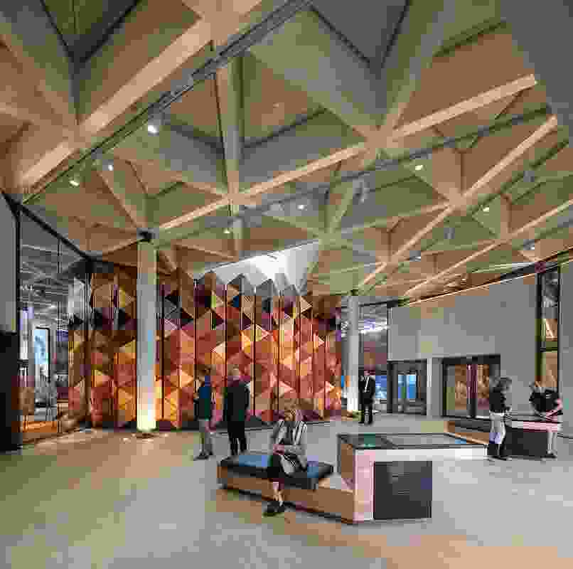 A large concertina screen of Australian timbers is the focal point of the lobby. Above it, a triangular skylight permits views of the lookout tower. Artwork (on left): Laurie Nilsen, Goolburris on Foreign Soil.
