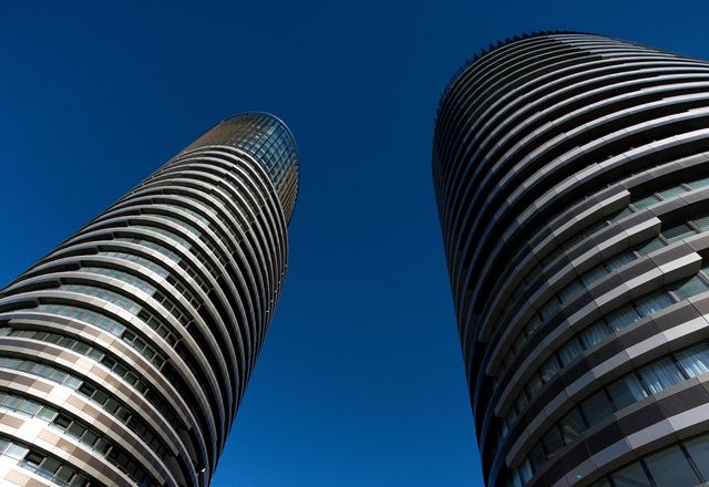 The twin elliptical towers of Australia Towers make for an impressive sight, with alternating striations of glazed surfaces and bronze panels.
