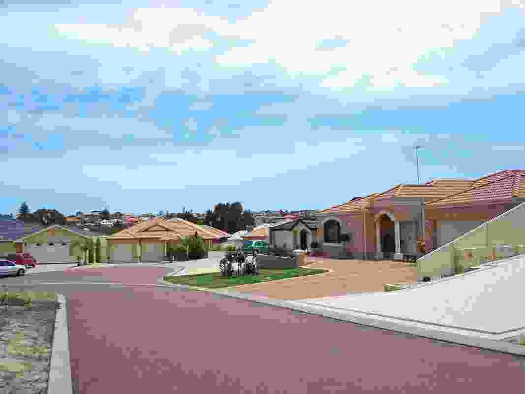 A street scene in Spearwood, Perth, Western Australia. Note the extensive paved areas, few windows and dominance of wide garages.