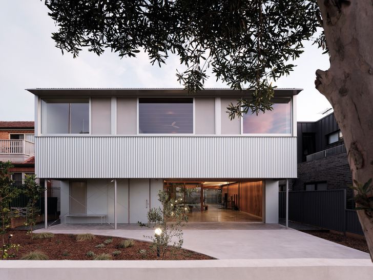 A tough outer skin of aluminum and steel envelops a timber-wrapped interior realm.