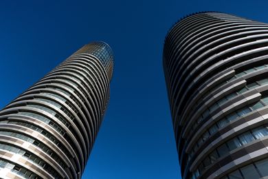 The twin elliptical towers of Australia Towers make for an impressive sight, with alternating striations of glazed surfaces and bronze panels.