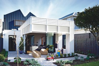 A covered patio at the back of the house references the look of the original cottage front.