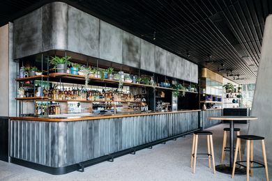 On the ground floor, House Bar features a patinaed copper bar at the rear of the space and seating with views to the harbour.