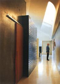 Looking along the east passage, with a tearshaped
skylight above and blue glazed brick bathroom box to the left.