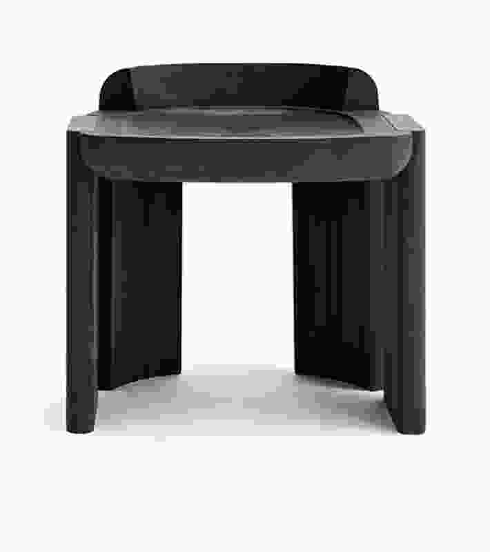 The Nevers stool in ebonized walnut wood has the same robust shapes as Cameron’s “Nevers” architecture photography.