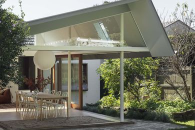 The south-facing addition steps up from the existing house and features an angled roof that draws in light and air.