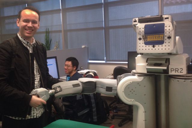 The author, Rory Hyde, looking extremely pleased to shake hands with BRETT, the Berkeley Robot for Eliminating Tedious Tasks.