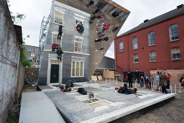 Reflections from a large mirror in Dalston House create the illusion that people are hanging off a real facade.