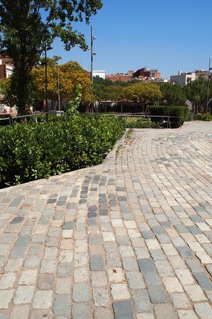 At Flores & Prats' Fabra and Coats Gardens, bricks salvaged from the site create a curved ripple pattern that echoes the line of a derelict brick wall.