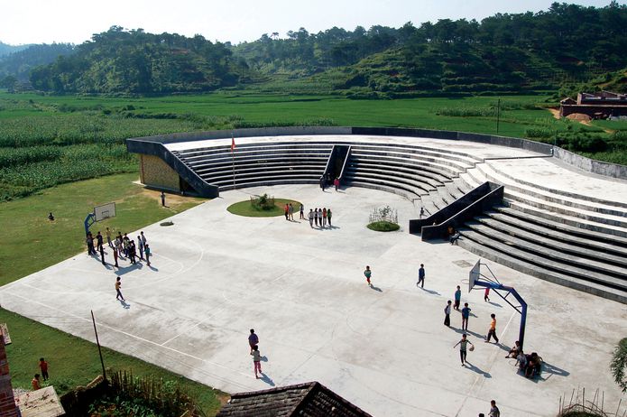 At the Qinmo Village project a school basketball court and playground double as community space.