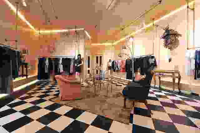 The main space with pink-nude-coloured walls and black-and-white chequerboard floor.