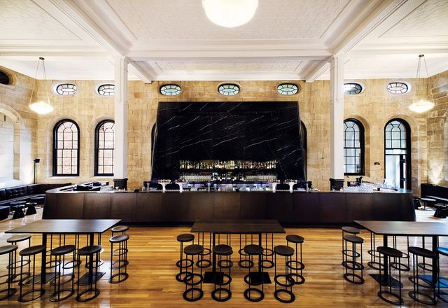 The main bar in black marble makes a brooding counterpoint to the restored sandstone.