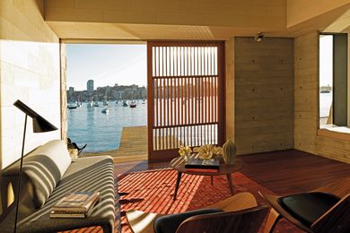 This boathouse hasn’t been “so much built as carved out of the sandstone” to provide a place from which to enjoy the waterfront.