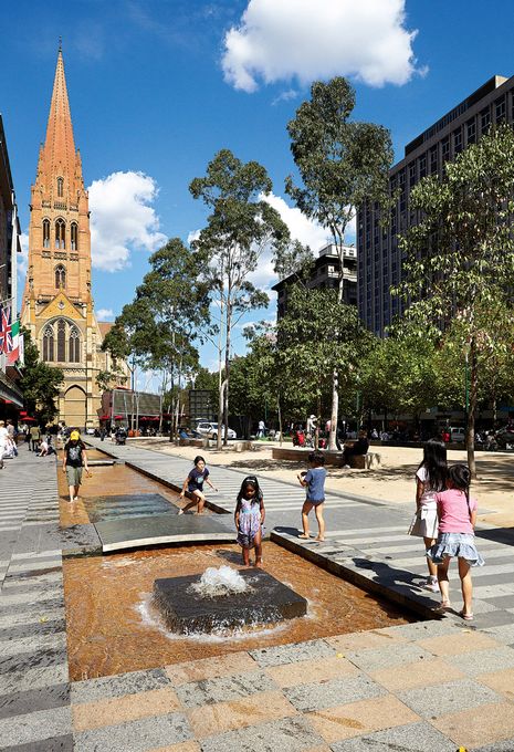 Children enjoy the City Square’s new fountains.