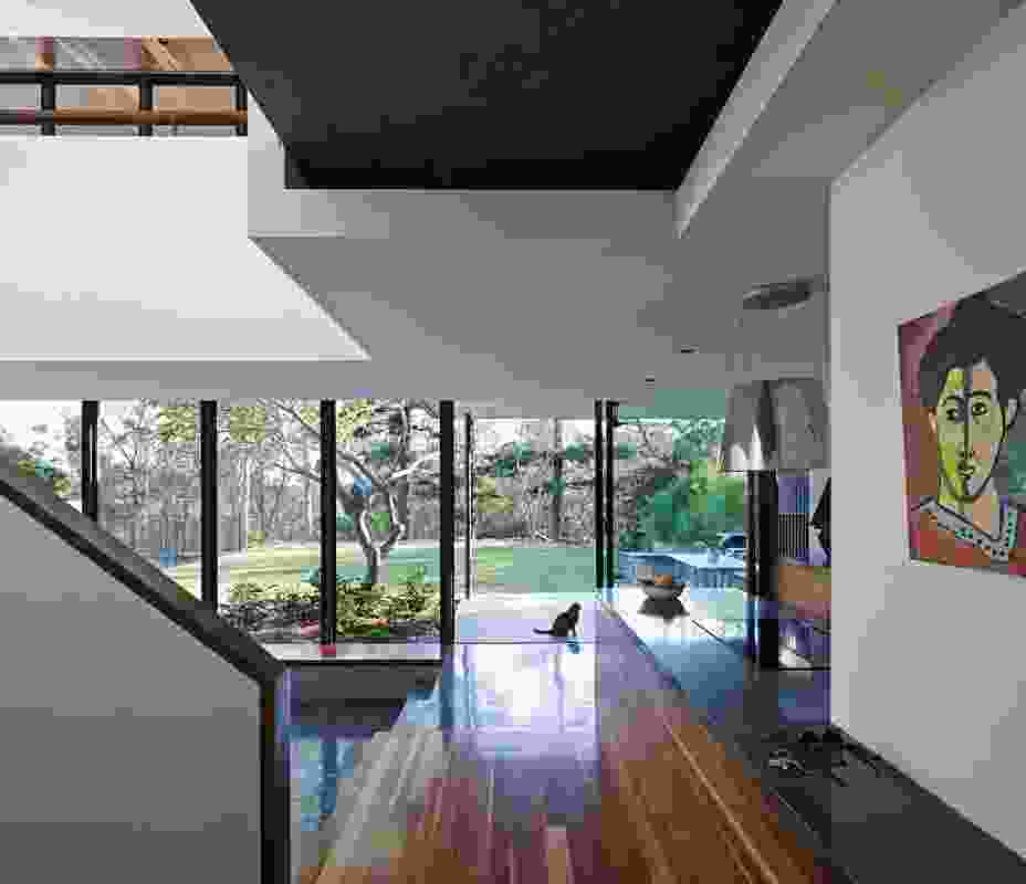 The living spaces are orientated toward the garden with an uninterrupted view of native bushland beyond. Artwork: Felix Gallagher.