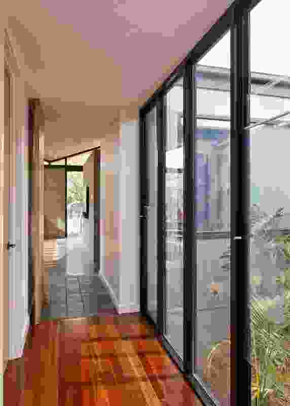 A secondary courtyard with a verdant garden provides cross ventilation.