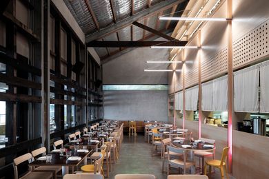 Set within an expansive volume, the contemporary dining area complements the rustic form of the heritage wharf building.