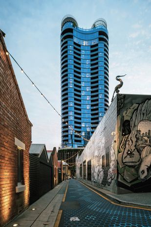 The Standard, with 24 residential levels as well as ground-level retail tenancies that activate the street, is designed by Woods Bagot to be an extension of the Fish Lane precinct. Artwork: Sofles