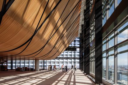 The topmost level features a sweeping modular timber ceiling that conceals the plant room and other utilities.