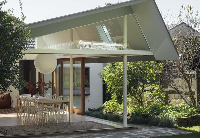 The south-facing addition steps up from the existing house and features an angled roof that draws in light and air.